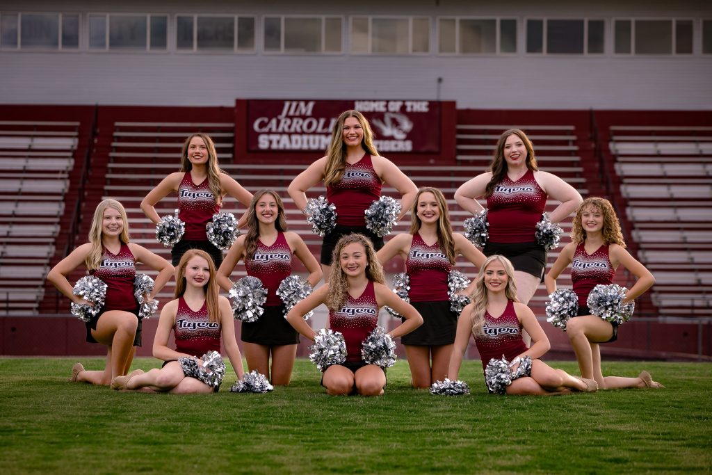 picture of the tiger motion dance team standing in three rows. All members are wearing their tiger motion cheerleading uniforms that are maroon and black
